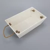 Kép 1/4 - Trapéz alakú fehér dekoláda - kötél füles 15,5x26cm